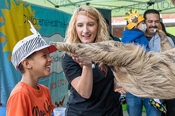 A boy meets a sloth at the SD Zoo