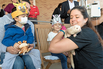 Children meet a ferret at the SD Zoo