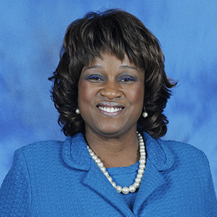 headshot of Dr. Deborah Le Blanc. She has short wavy hair and a blue suit with a pearl necklace.