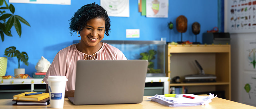 Toya S. - Class of 2019 sits in her classroom working on a laptop