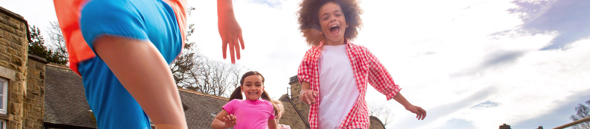 elementary school aged kids running and smiling