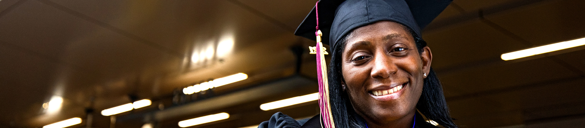 woman smiling with graduation cap on