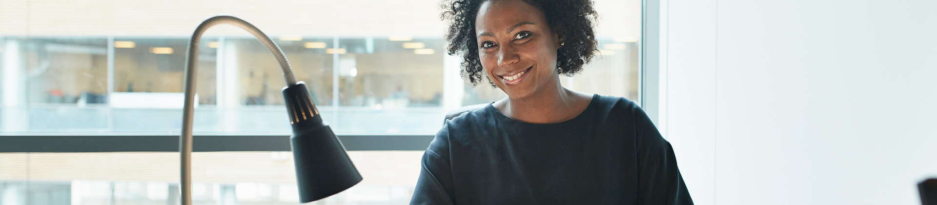 Woman in office building sitting at her desk